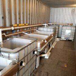 A room with three large tanks and pipes.